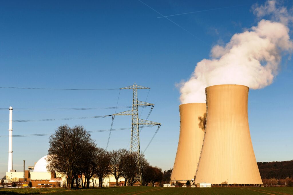A nuclear power plant in Hameln, Germany, showcasing cooling towers and electricity pylons.