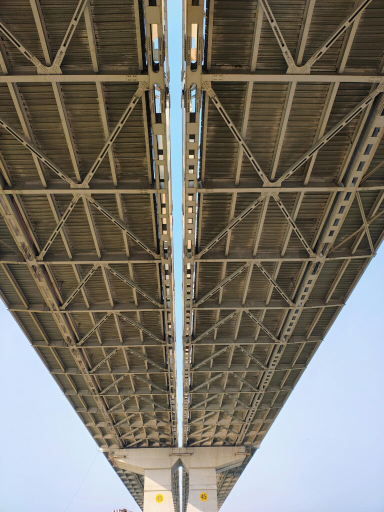 Dramatic view from below of a steel bridge, showcasing industrial design.